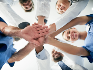 Doctors all touching hands